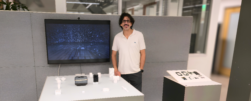 Image of Steven Bathiche with a table of new technology from Microsoft on display