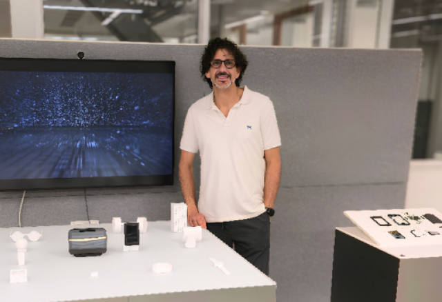 Image of Steven Bathiche with a table of new technology from Microsoft on display